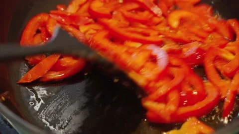Frying red pepper in a pan. Vegetarian cuisine. Healthy food concept. Stock Footage 152588380