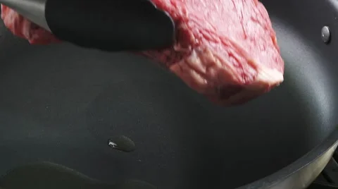 Frying rib eye steak in a frying pan Video stock 8572785
