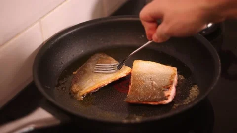 Frying salmon fillet on a pan. Stock Footage 144357359