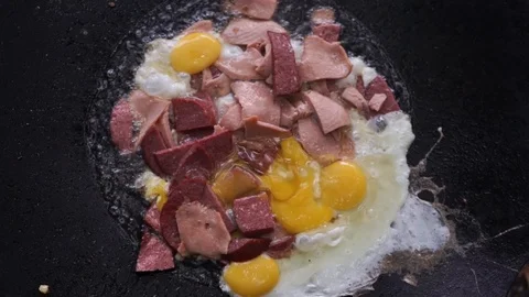 Frying sausage with eggs and bacon. Cooking omelette with meat Stock Footage 114631278