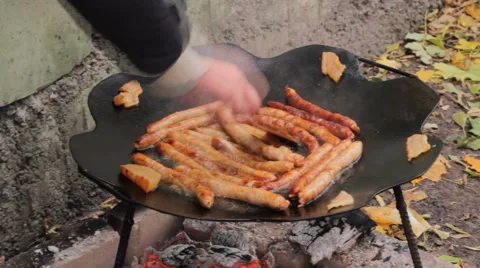 Frying sausages with bacon on the pan  Stock-Footage 51387330