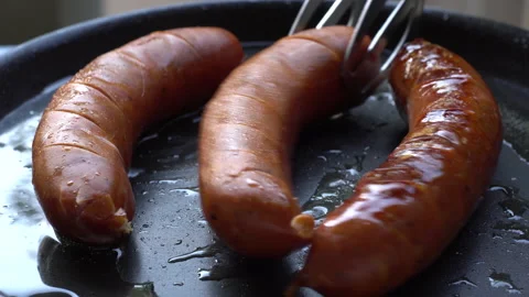 Frying sausages. Close up. Pan leftto right Stock Footage 143936059