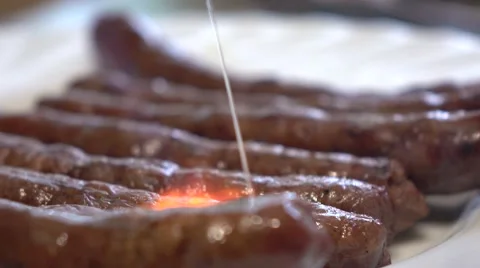 Frying sausages with food burner. 4K close up video Stock Footage