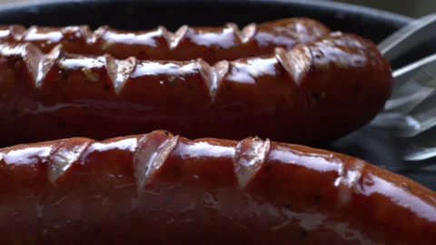 Frying sausages in a hot pan. Close up. Stock Footage 143936129
