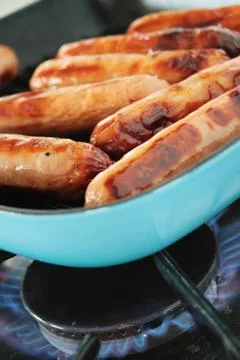 Frying sausages Stock Photos