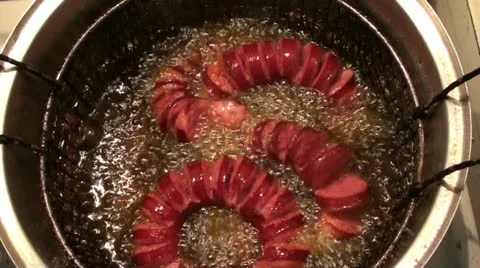Frying sausages in the pot Stock Footage 22384561