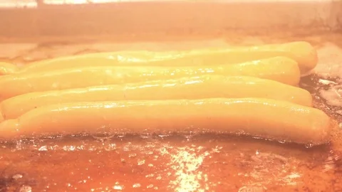 Frying Sausages - slow motion. Junk food. Frying in oil Video stock 83793458