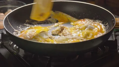 Frying scrambled eggs Stock Footage 98178871