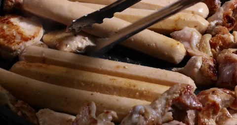Frying skinless small chicken fillet pieces sausage bangers in lightly coat.. Stock Footage 267059942