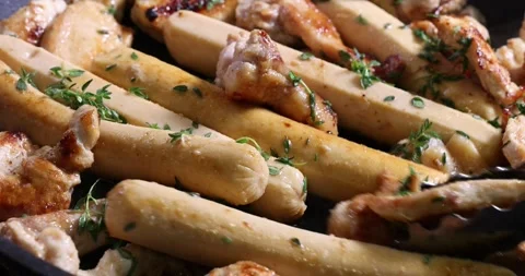 Frying skinless small chicken fillet pieces sausage bangers in lightly coat.. Stock Footage 267059987