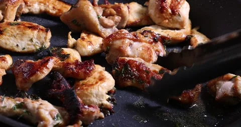 Frying skinless small chicken fillet pieces in lightly coated oil thyme her.. Stock Footage 267060104