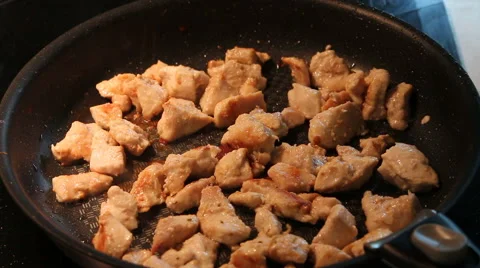 Frying sliced chicken meat frying pan close up Stock Footage 67006867