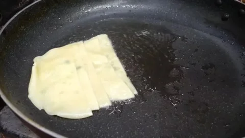Frying Sliced Korean Fish Cakes (Eomuk) in a Non-Stick Pan, Macro Close-up Stock Footage 337374255