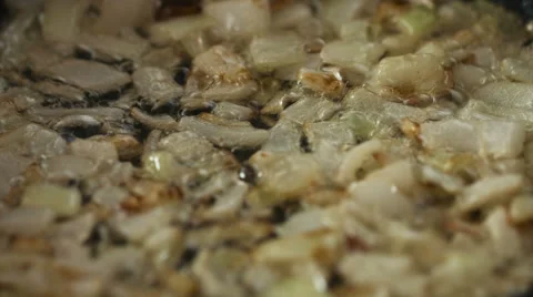 Frying sliced onions in a pan closeup Stock Footage 62474841