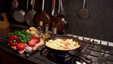 Frying sliced potatoes in a frying pan Stock Footage 176483130