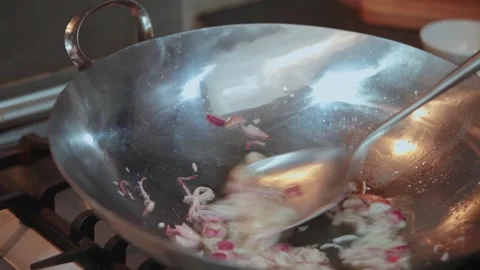 Frying Sliced Shallots and Chili in Large Metal Wok Pan Close Up 스톡 동영상 339555481