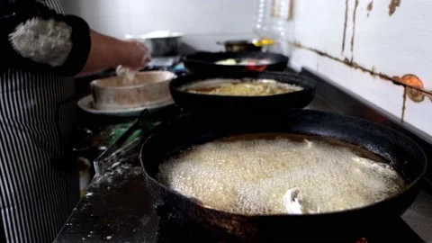 Frying small surmullet fish in boiling oil on frying pan Stock Footage 220603029