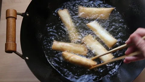 Frying Spring Rolls In A Wok Stock Footage 232970519