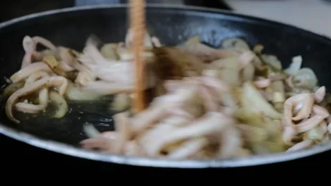 Frying squid rings with spices and onion in frying pan Stock Footage 161779251
