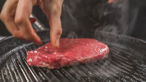 Frying steak in a frying pan Stock Footage 76454153
