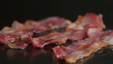 Frying strips of bacon on grill. Burger ingredients Stock Footage 140329988