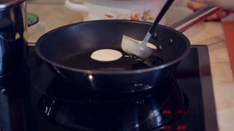 Frying sweet thick pancakes on a pan Stock Footage 79669908