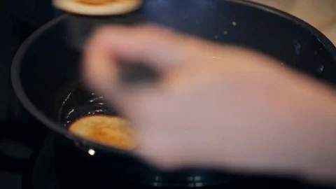 Frying sweet thick pancakes on a pan Stock Footage