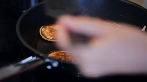 Frying sweet thick pancakes on a pan Stock Footage 79669928