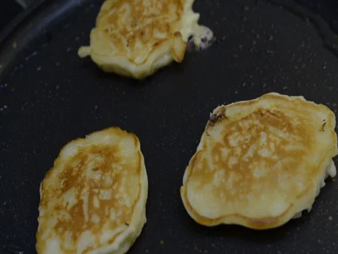 Frying sweet thick pancakes on a pan. Stock Footage 80822100