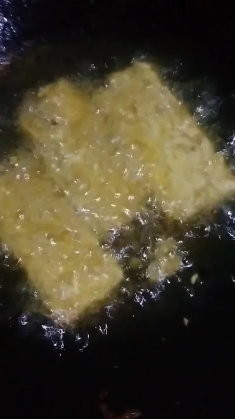 Frying tempeh Stock Footage 257782981