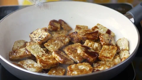 Frying tempeh with a sauce Stock Footage 71681176