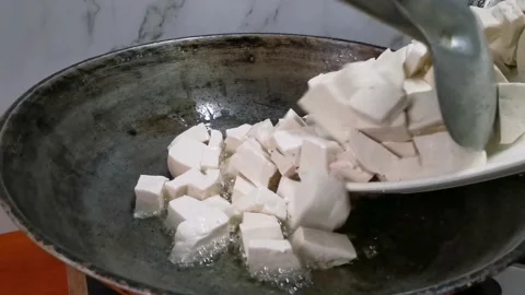 Frying Tofu Cubes in a Frying Pan Stock Footage 157676500