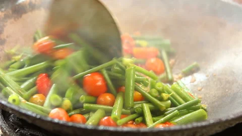 Frying tomato with spring onion in pan , in door  Chiangmai  Thailand Stock Footage 147576749