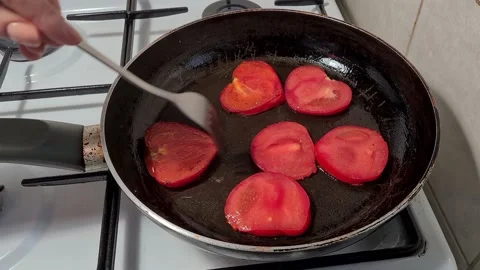 Frying the tomatoes to make the omelet Stock-Footage 164158605