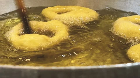 Frying traditional Peruvian picarones. 動画素材 344988575