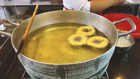 Frying Traditional Peruvian Picarones in Hot Oil Video stock 339078658