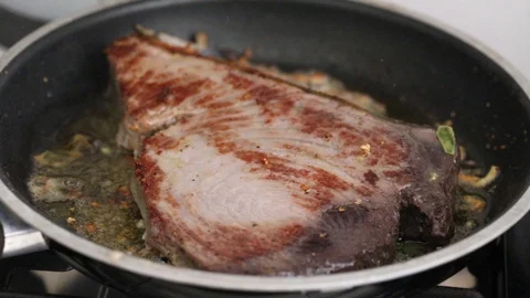 Frying tuna with bay leaf on frying pan Video stock 116735317