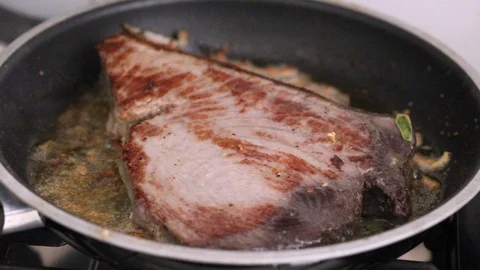 Frying tuna with bay leaf on frying pan Video stock 116735449