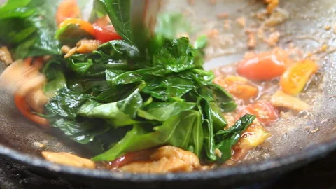 Frying  vegetable with chopped chicken in pan , in door  Chiangmai  Thailand Stock Footage 154671514