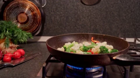 Frying the vegetable mixture in a frying pan, on a gas stove. Stock Footage 172446305