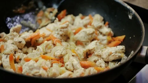 Frying vegetables and chicken Stock Footage 98361636