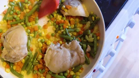 Frying vegetables and chicken, Top View Stock Footage 73995190