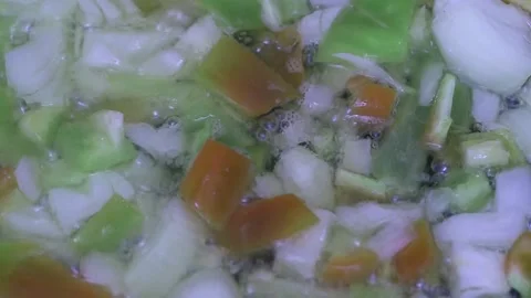 Frying vegetables in a frying pan for cooking dinner, close-up Vídeos de archivo 221736320