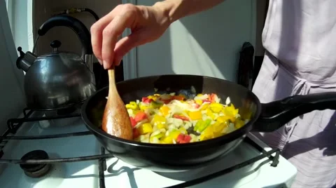 Frying vegetables at kitchen at sunny summer day Stock Footage 67611793