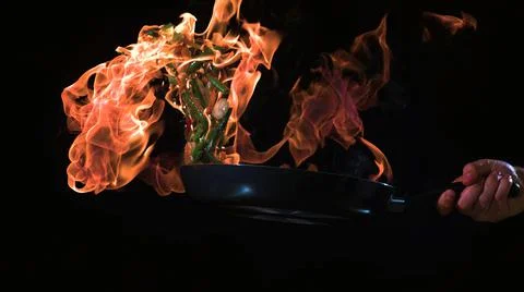 Frying vegetables in a pan in the air Stock Photos