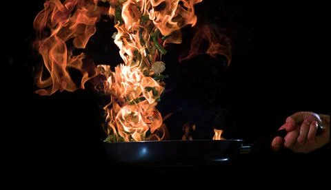 Frying vegetables in a pan in the air Stock Photos