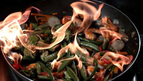 Frying vegetables in a pan in the air Foto stock