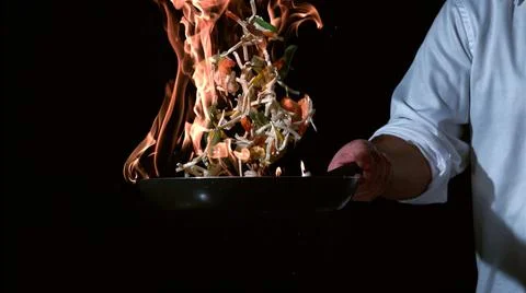 Frying vegetables in a pan in the air Stock Photos