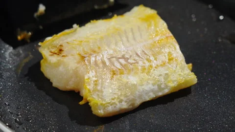 Frying white fish fillets. Frying hake fillets in a hot pan Detailed image. Video stock 348241037
