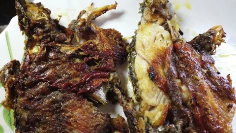 Frying whole tilapia fish in cooking oil | Stock Video | Pond5